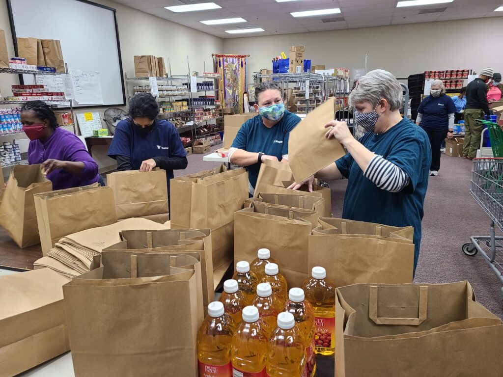 Women packing boxes with food items