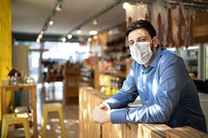 Business owner in mask