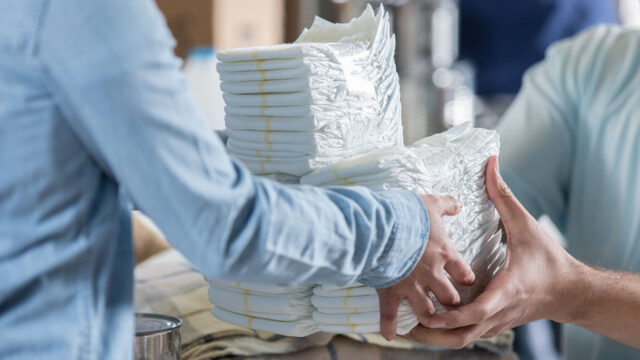 Woman donates diapers during clothing drive.